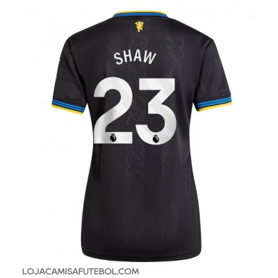 Camisa de Futebol Manchester United Luke Shaw #23 Equipamento Alternativo Mulheres 2025-26 Manga Curta Camisa de Futebol Manchester United Luke Shaw #23 Equipamento Alternativo Mulheres 2025-26 Manga Curta